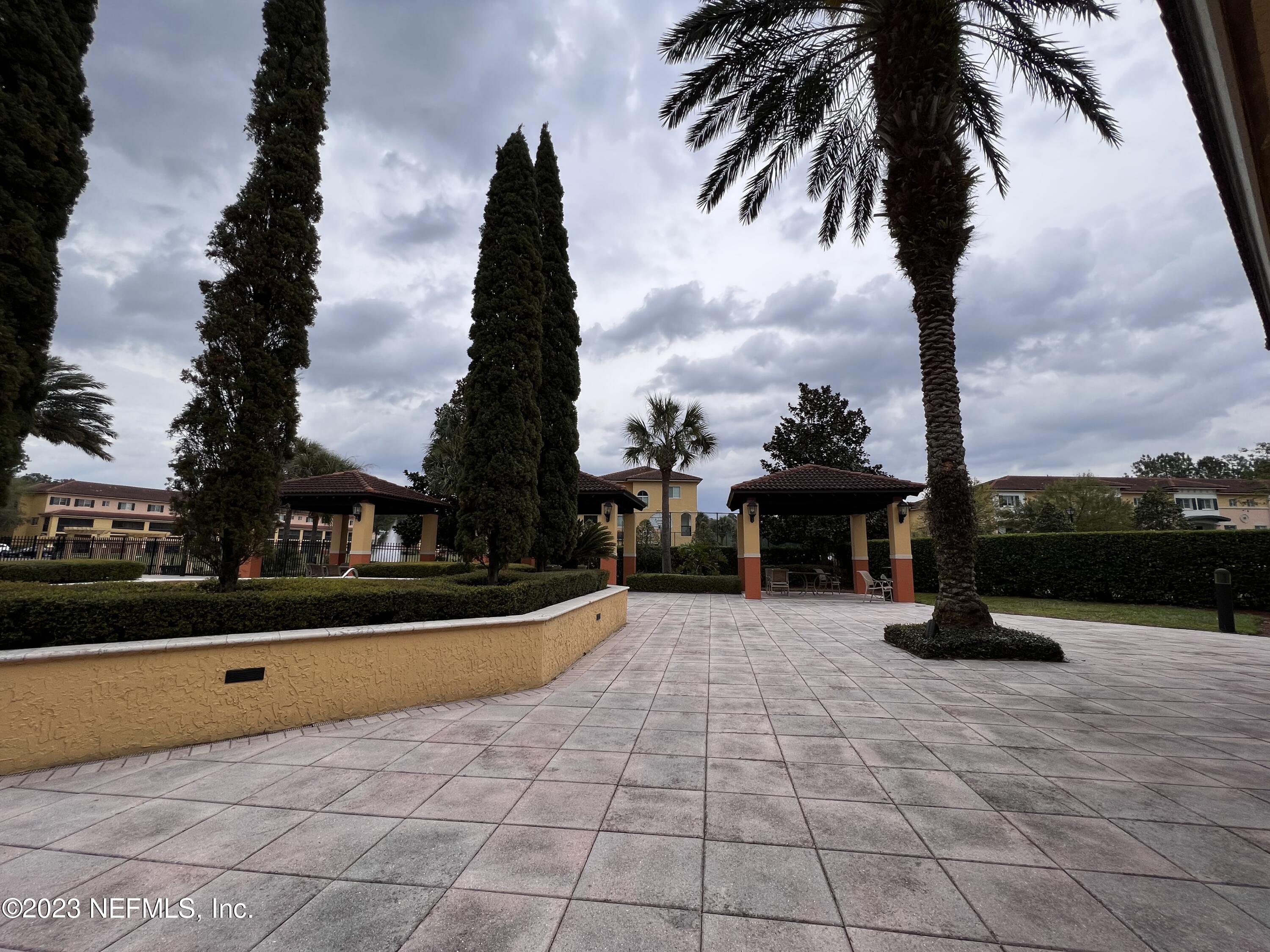 9745 Touchton Road, Unit 1702 Jacksonville, FL 32246 - Photo 52 of 62 a view of swimming pool with a table and palm trees