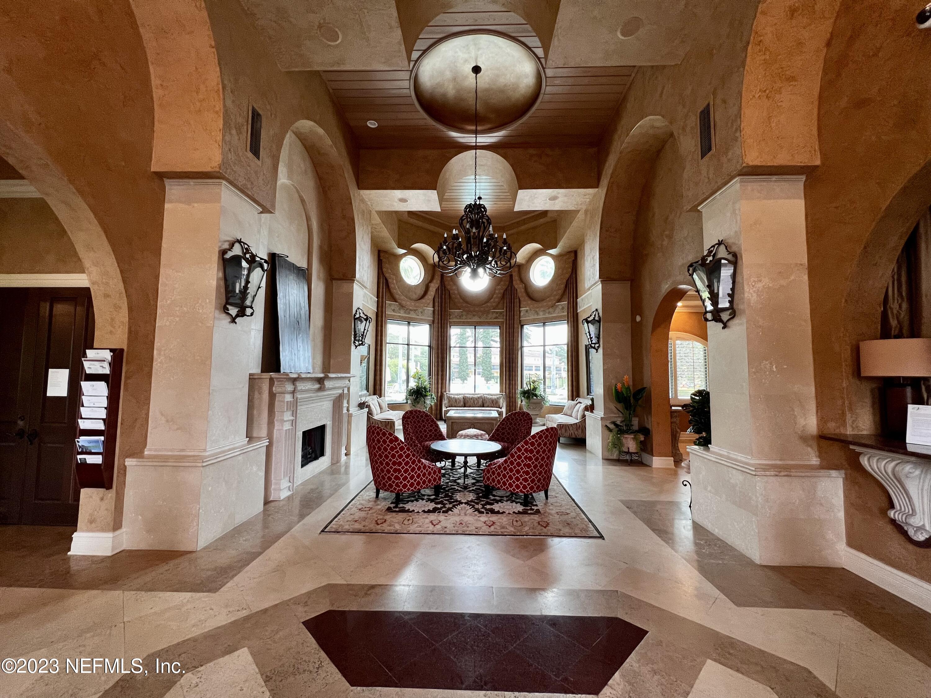 9745 Touchton Road, Unit 1702 Jacksonville, FL 32246 - Photo 54 of 62 a living room with fireplace furniture and a chandelier