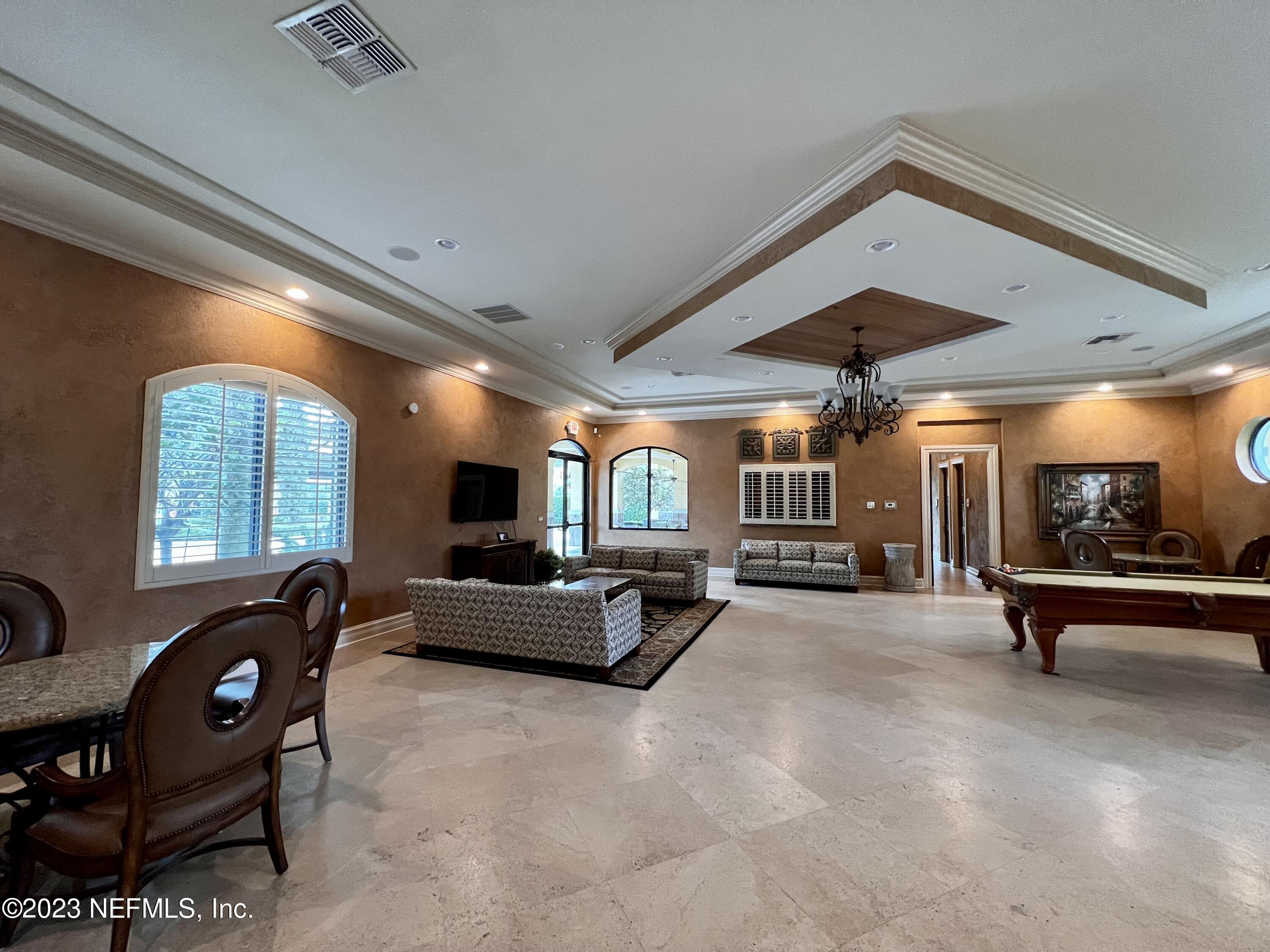 9745 Touchton Road, Unit 1702 Jacksonville, FL 32246 - Photo 55 of 62 a living room with furniture and a flat screen tv