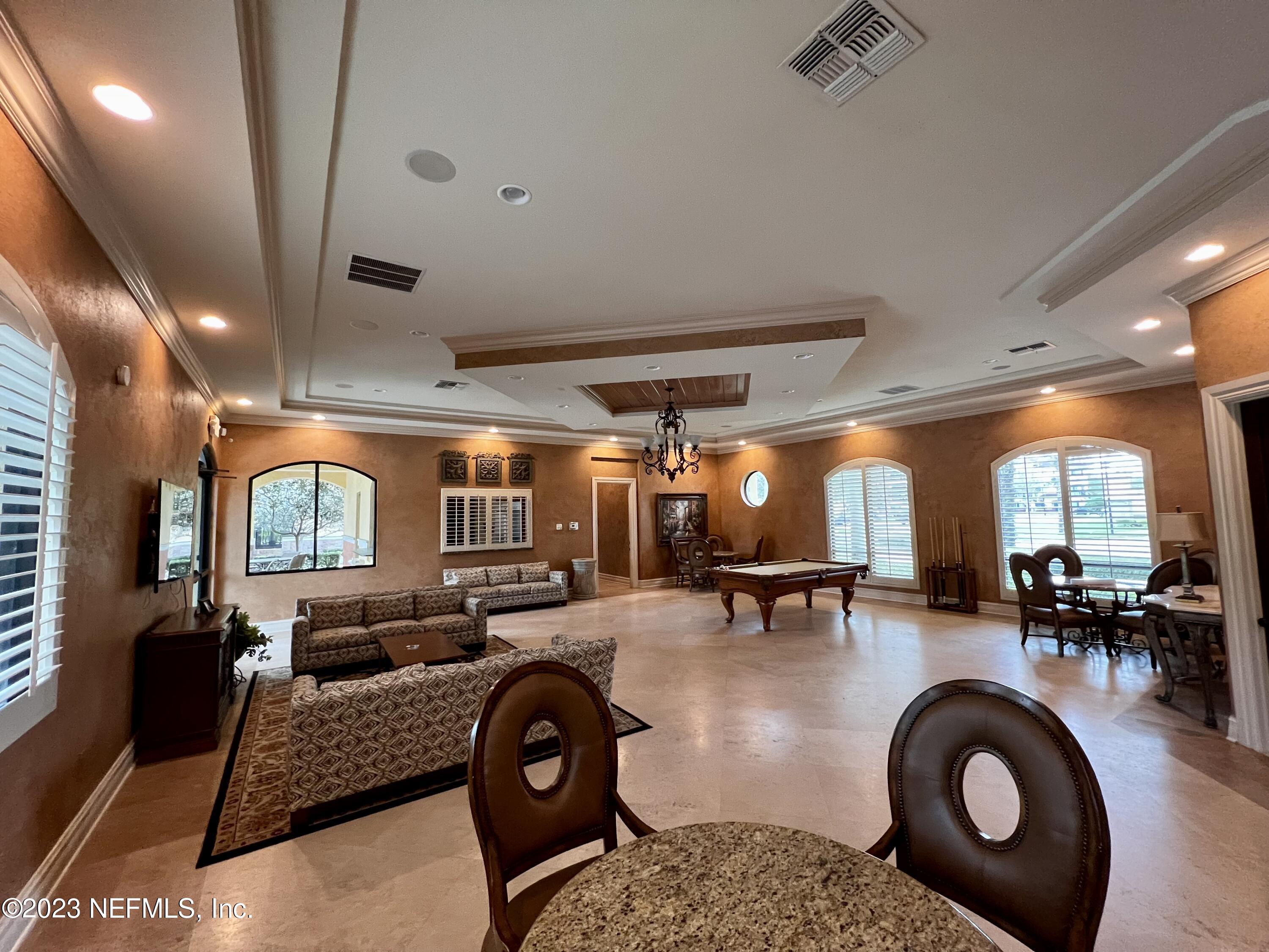9745 Touchton Road, Unit 1702 Jacksonville, FL 32246 - Photo 56 of 62 a living room with furniture a large window and gym equipment