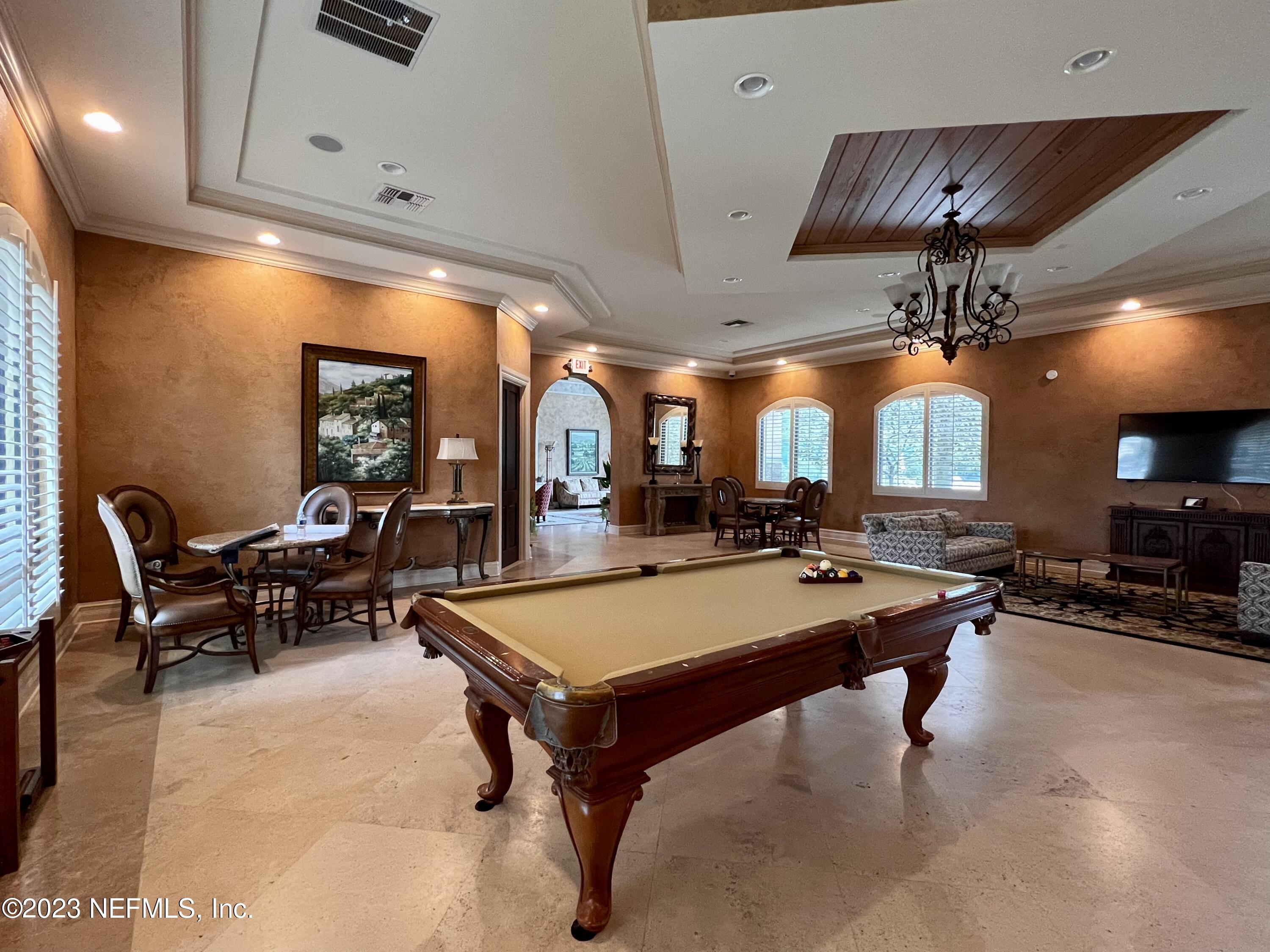 9745 Touchton Road, Unit 1702 Jacksonville, FL 32246 - Photo 59 of 62 a room with lots of tables a chandelier and a dining table