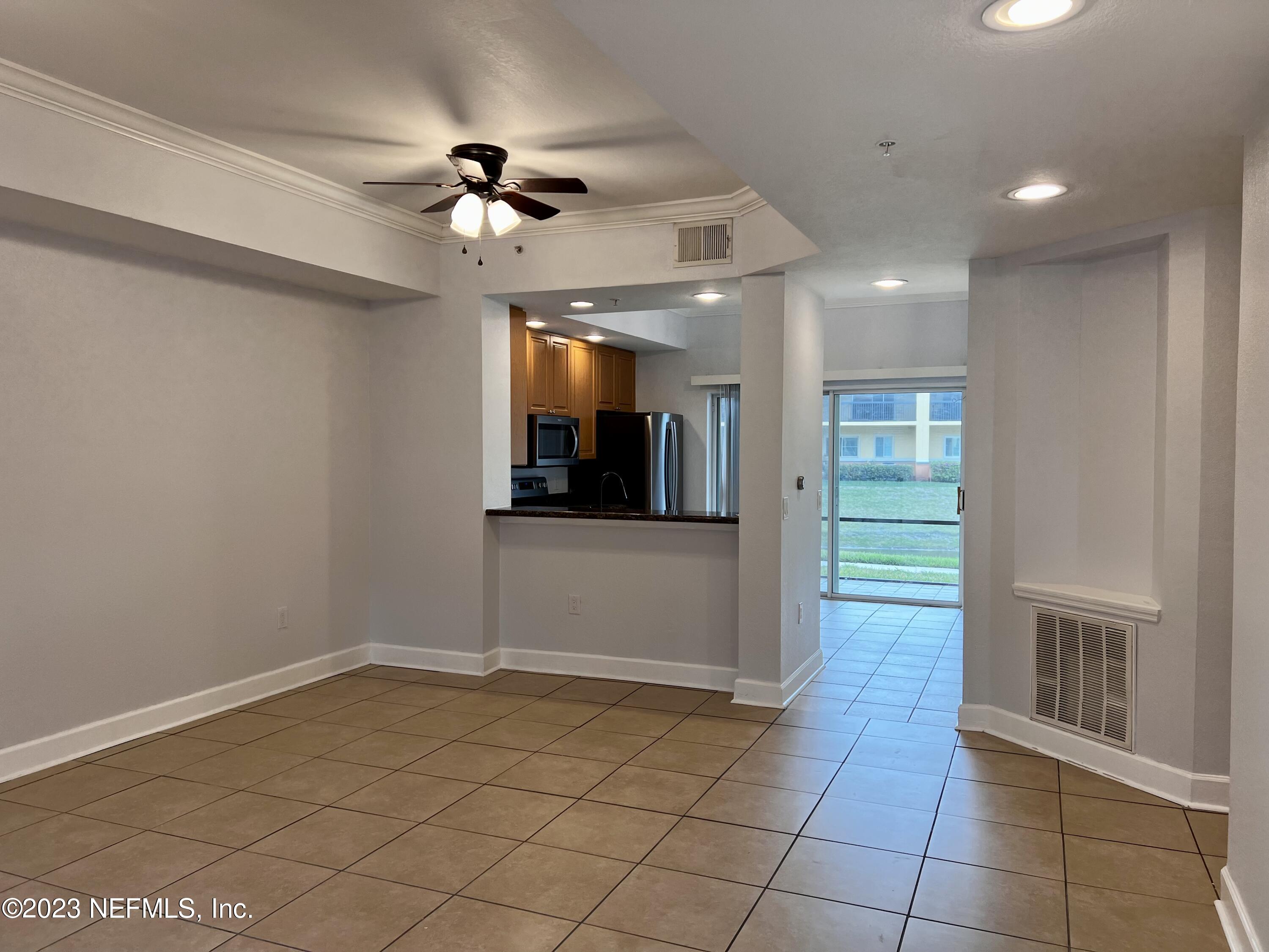 9745 Touchton Road, Unit 1702 Jacksonville, FL 32246 - Photo 6 of 62 a view of a livingroom with a ceiling fan and window
