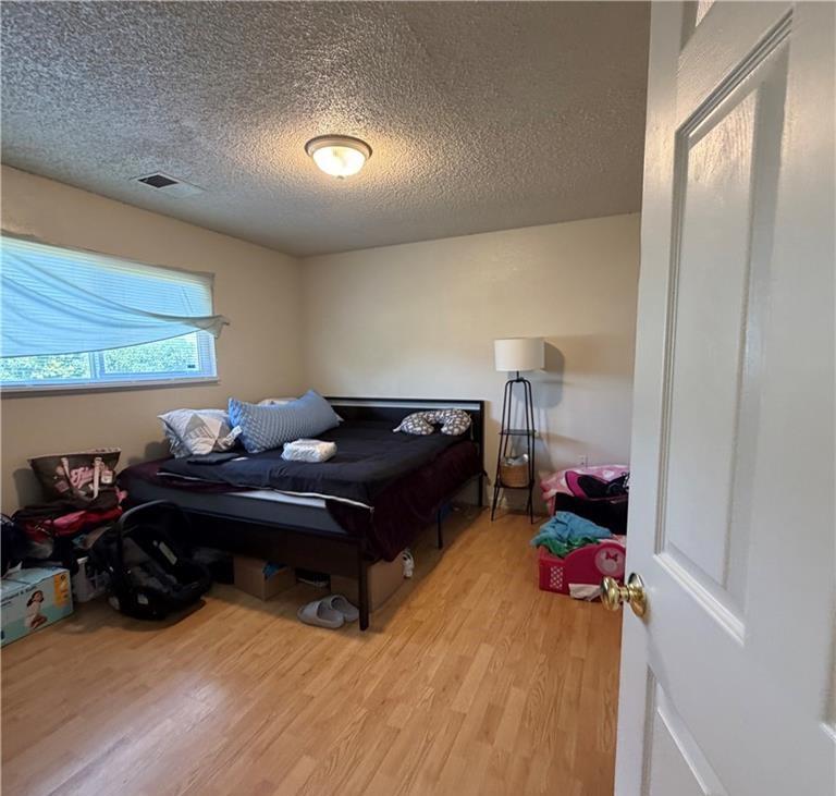 1567 Ellen Court Merced, CA 95341 - Photo 3 of 16 a living room with furniture a flat screen tv and a floor to ceiling window