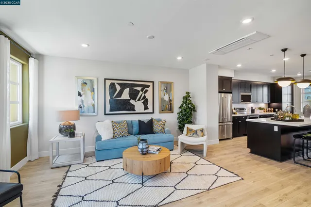 a living room with furniture and kitchen view