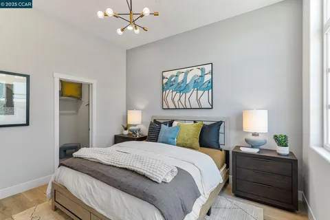 a bedroom with a bed and a chandelier