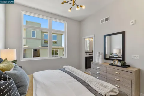 a bedroom with a large bed and a dresser