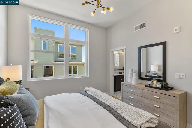 a bedroom with a large bed and a dresser