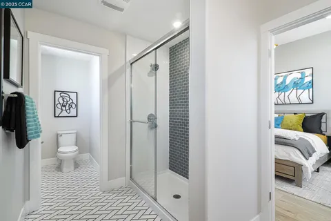 a bathroom with a toilet and a shower