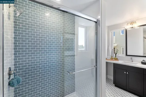 a bathroom with a sink a mirror and shower