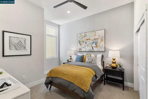 a bedroom with a bed and a painting on the wall