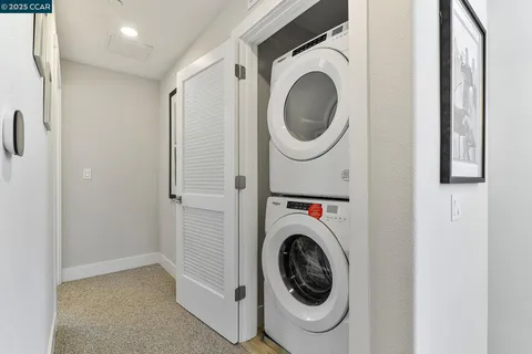 a view of a hallway with washer and dryer