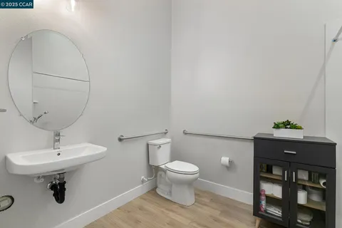 a bathroom with a sink toilet and a mirror