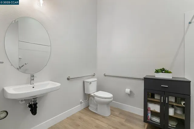 a bathroom with a sink toilet and a mirror