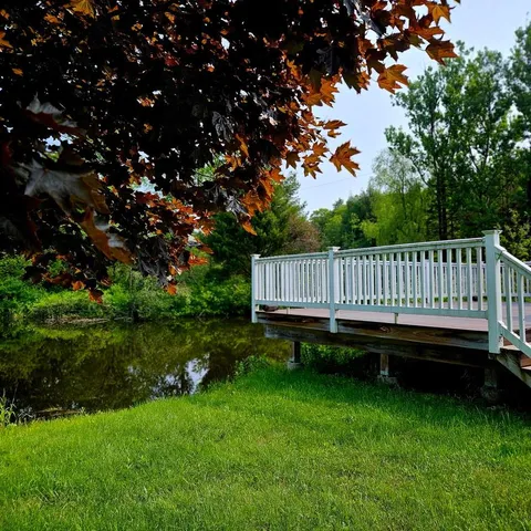 a view of a yard with wooden deck and garden