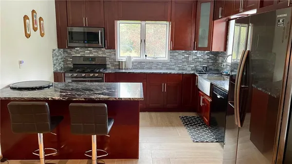 a kitchen with a sink a counter top space and a window