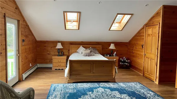 a bedroom with a bed chair and a window