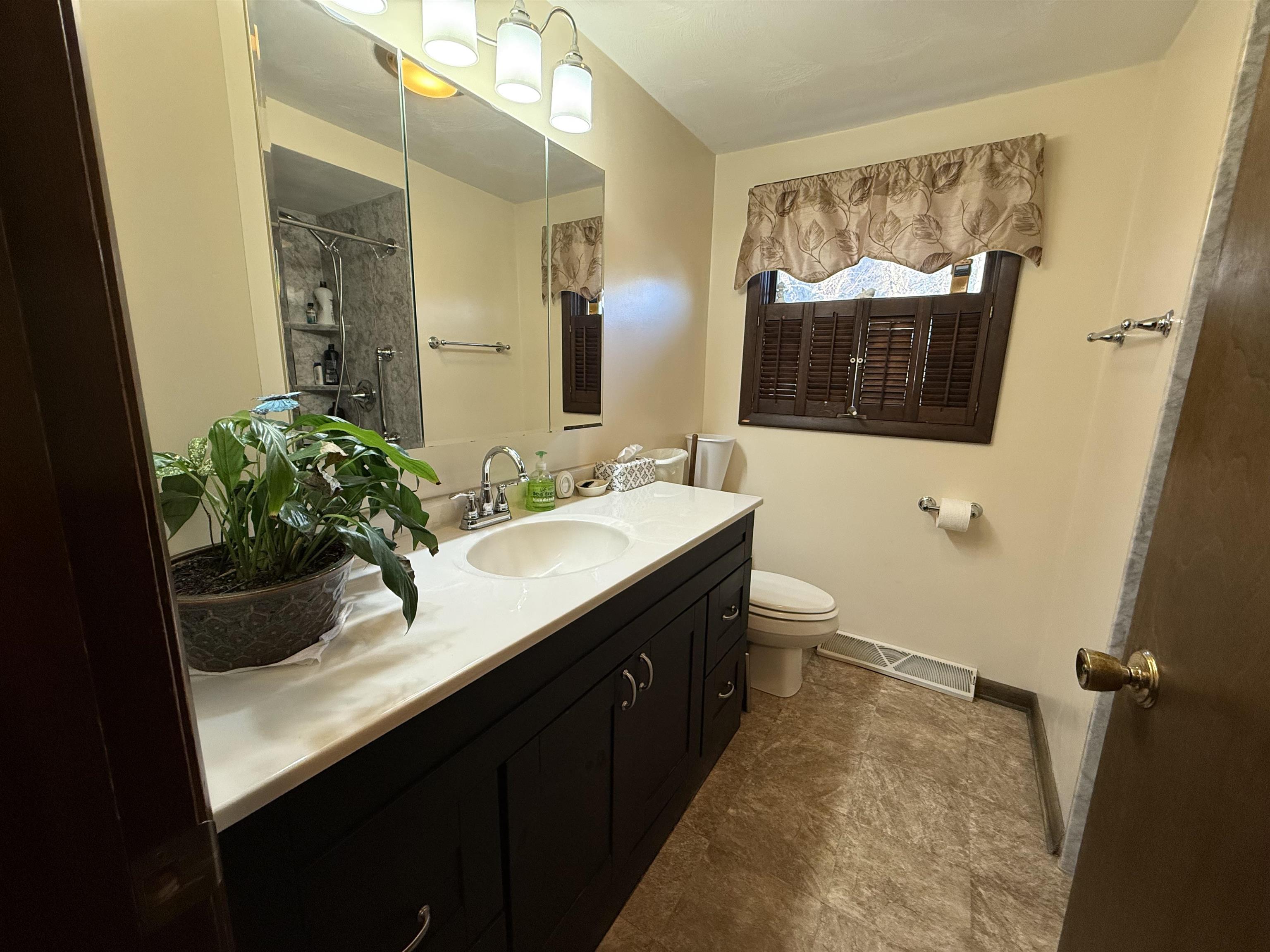 629 North Dakota Road Ridott, IL 61067 - Photo 18 of 26 a bathroom with a sink a toilet and mirror