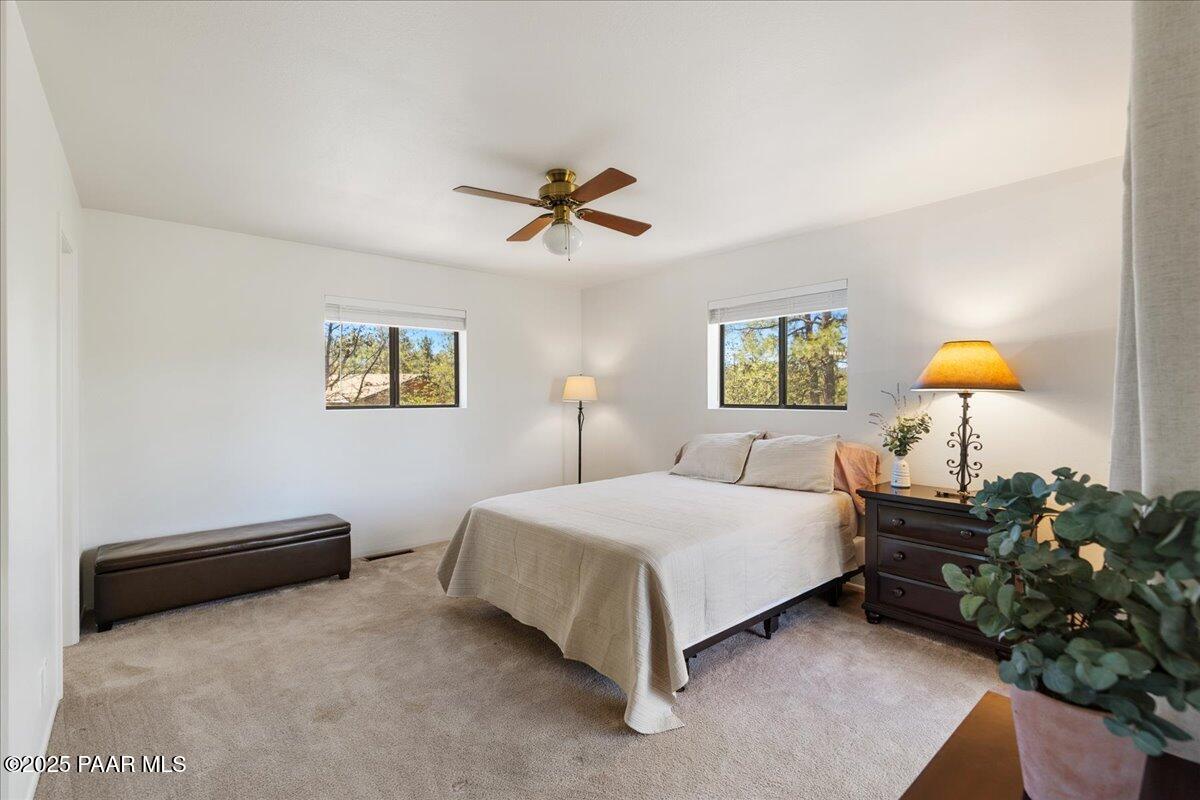 1271 Tanglewood Road Prescott, AZ 86303 - Photo 12 of 18 a bedroom with a bed and a chandelier