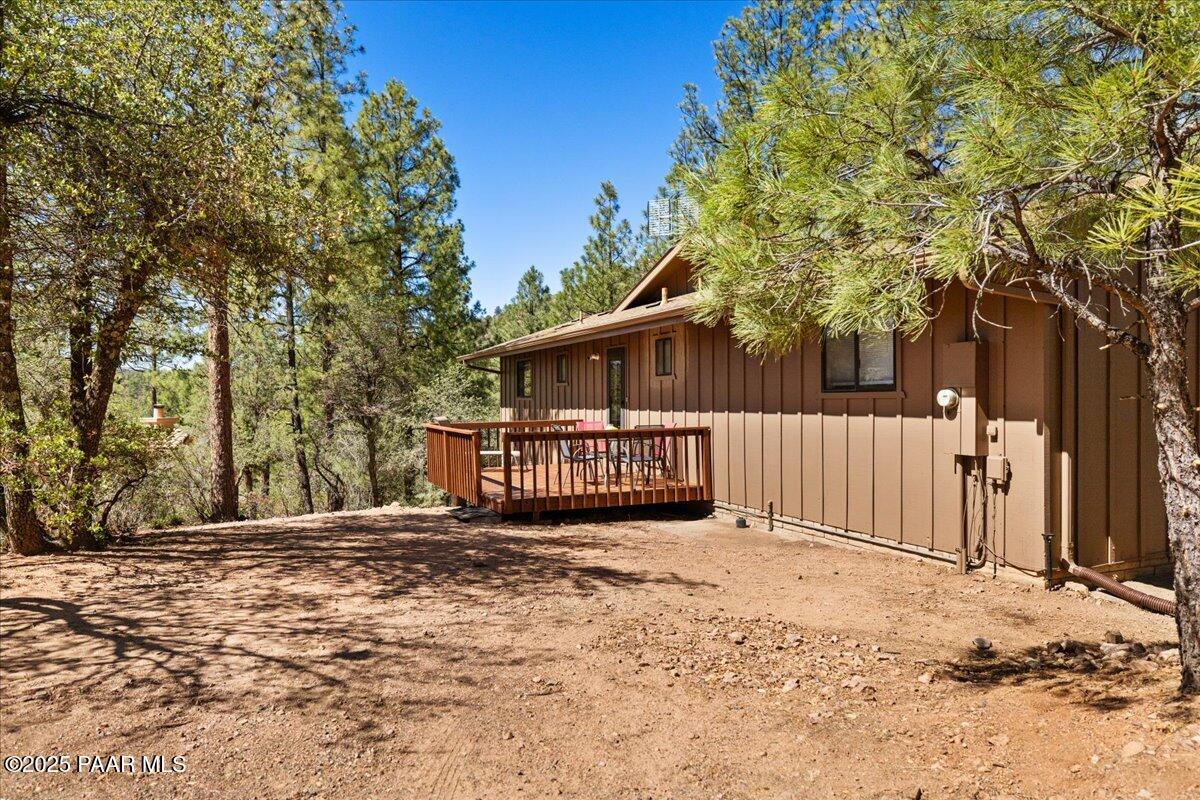 1271 Tanglewood Road Prescott, AZ 86303 - Photo 17 of 18 a view of a house with a large tree and wooden fence
