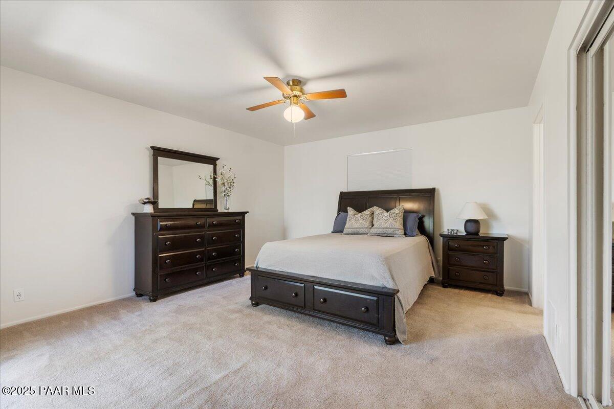 1271 Tanglewood Road Prescott, AZ 86303 - Photo 10 of 18 a bedroom with a bed and ceiling fan