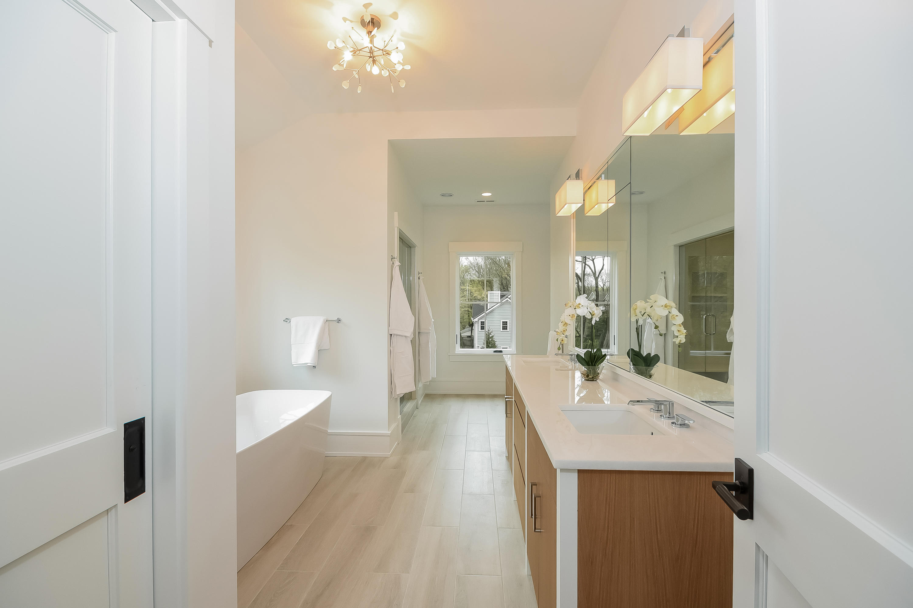 14 Clocks Lane Darien, CT 06820 - Photo 28 of 46 a bathroom with a sink a mirror and a bathtub