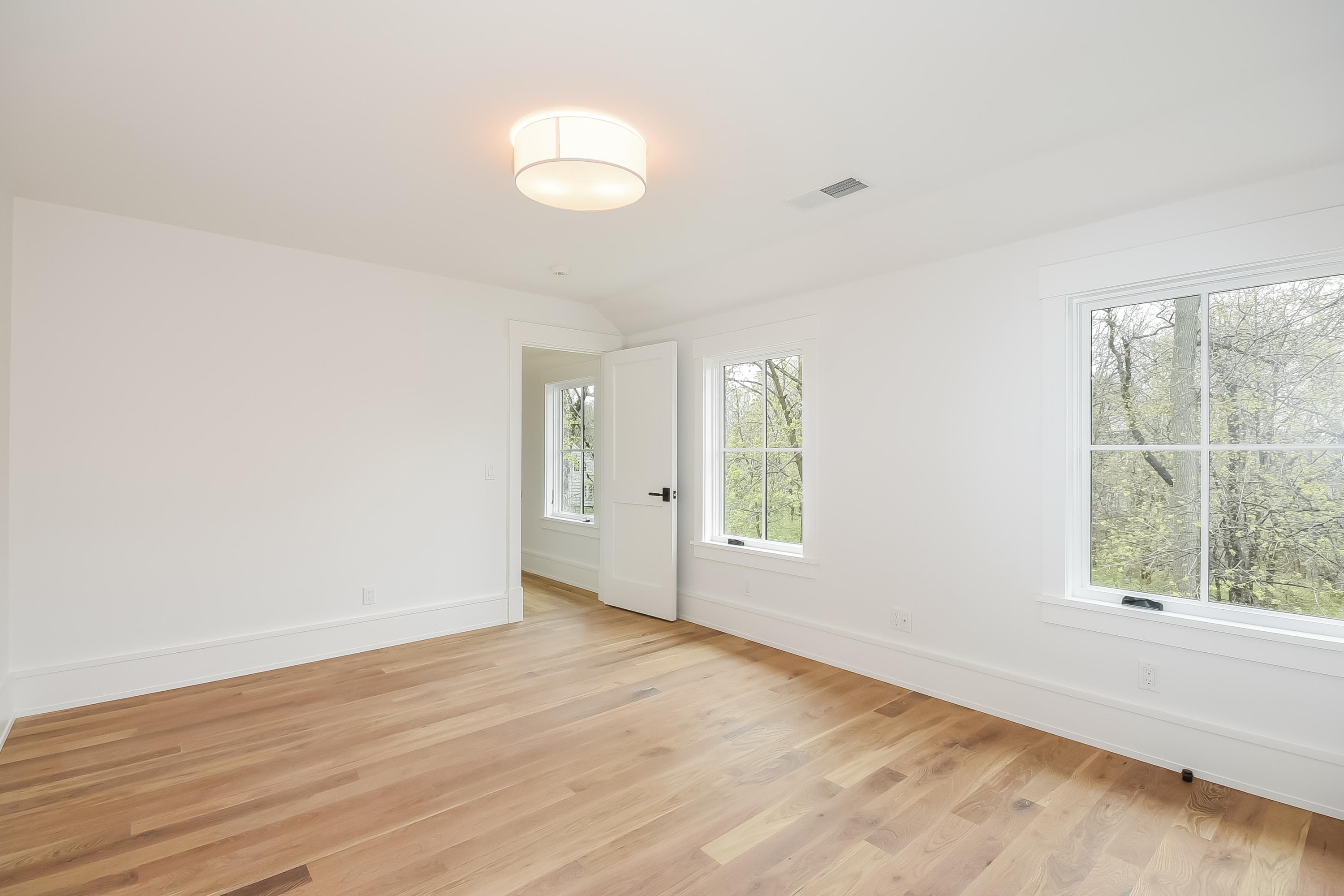 14 Clocks Lane Darien, CT 06820 - Photo 32 of 46 an empty room with wooden floor and windows