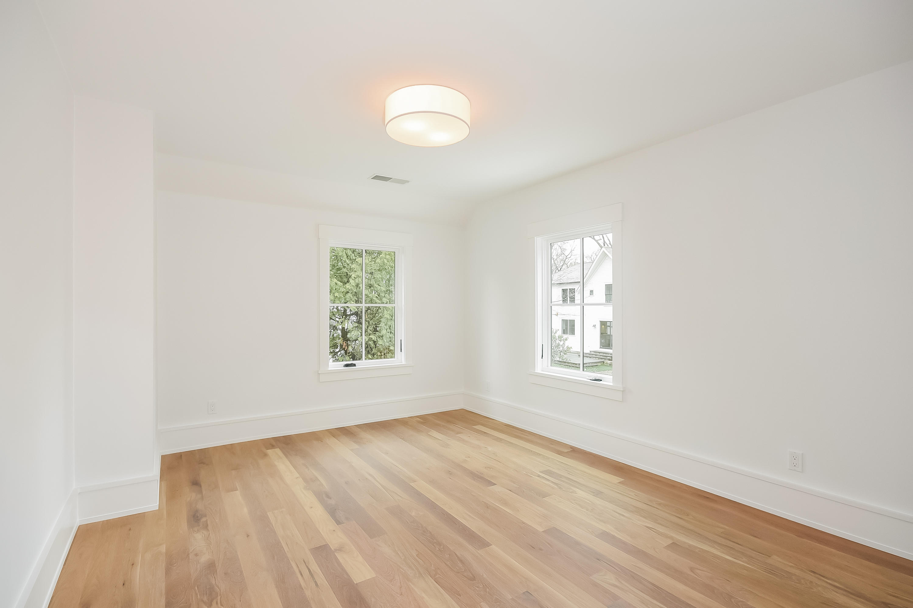14 Clocks Lane Darien, CT 06820 - Photo 33 of 46 an empty room with wooden floor and windows