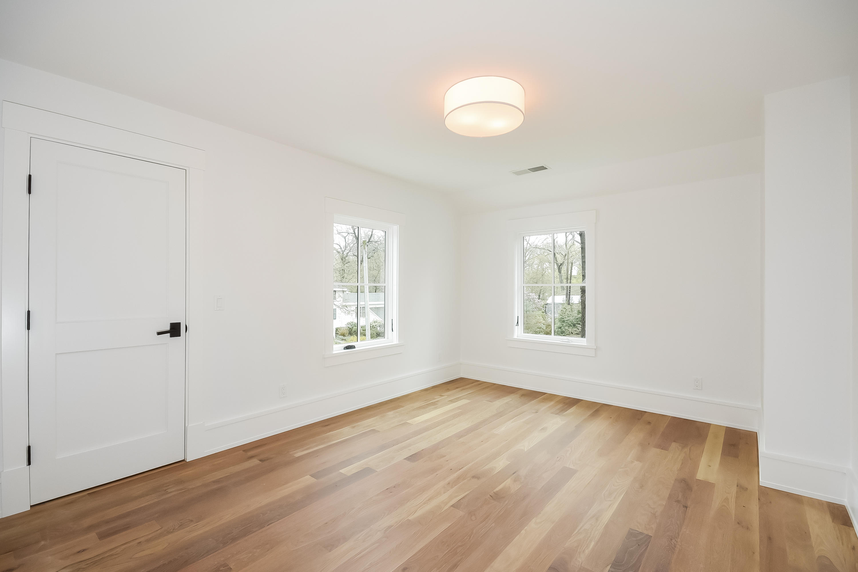 14 Clocks Lane Darien, CT 06820 - Photo 34 of 46 a view of an empty room with wooden floor and a window