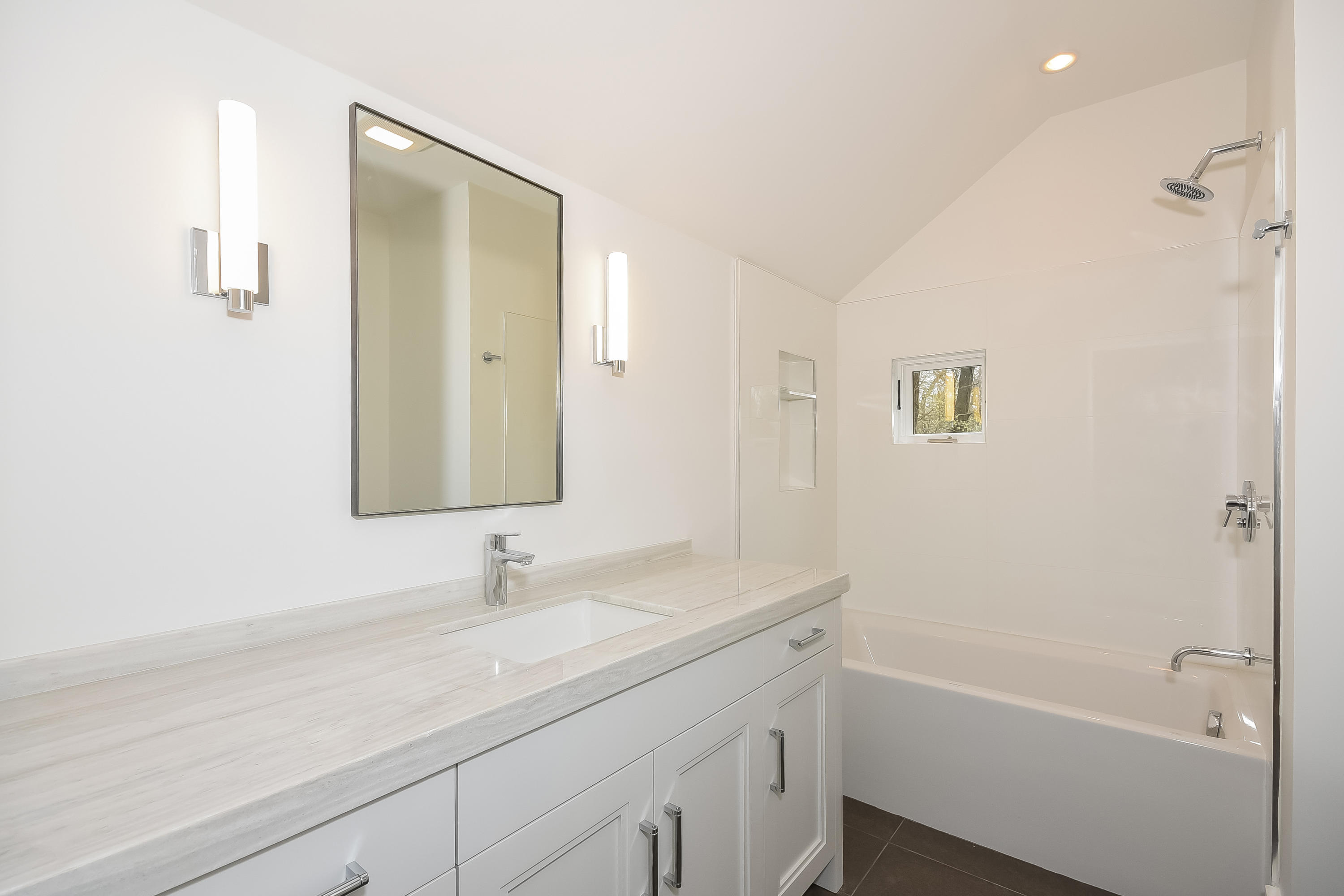 14 Clocks Lane Darien, CT 06820 - Photo 36 of 46 a bathroom with a sink a mirror and a bathtub