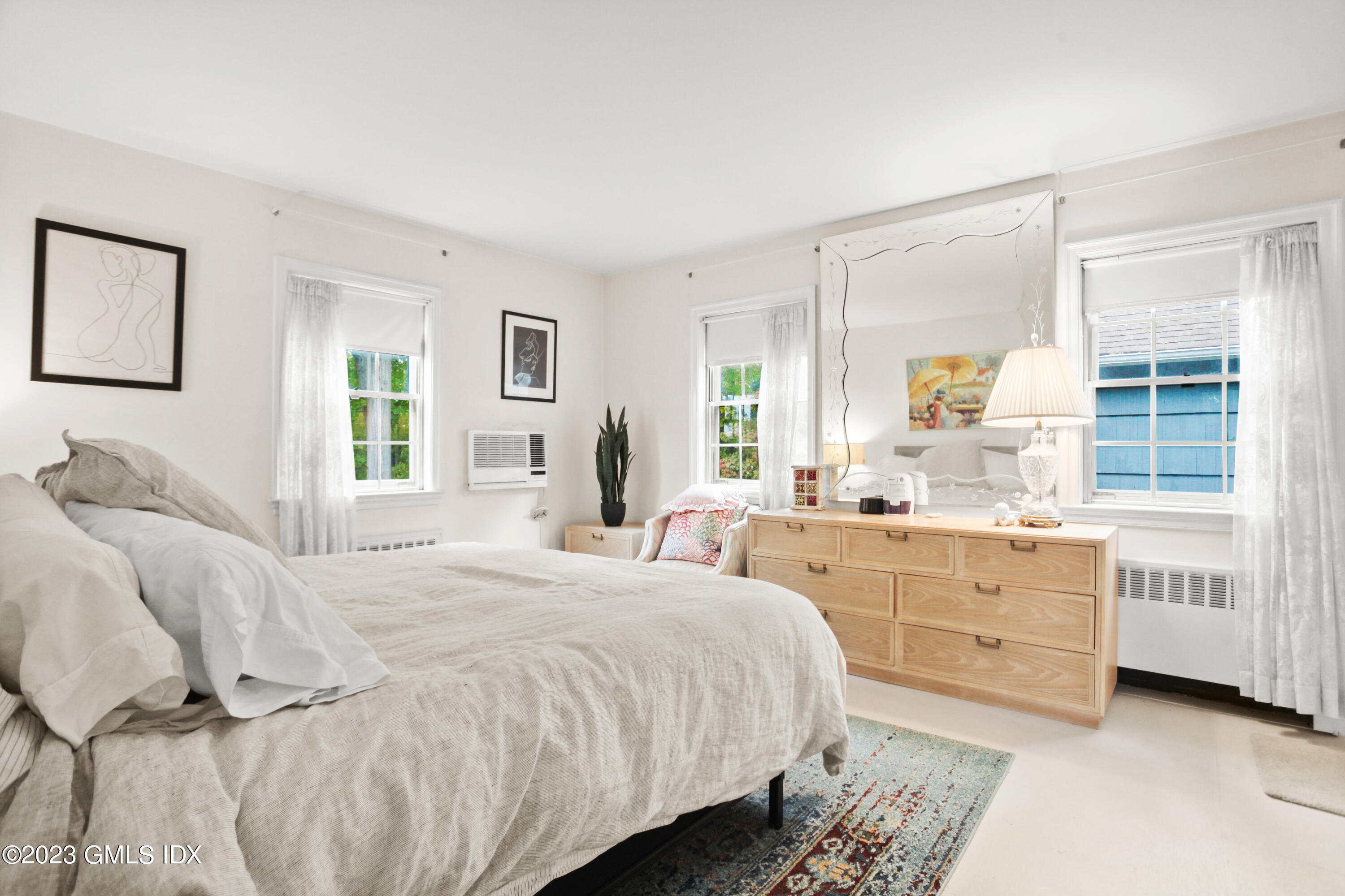 180 Byram Shore Road Greenwich, CT 06830 - Photo 11 of 29 a bedroom with a bed and a large window