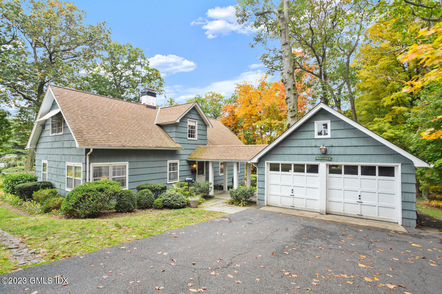 180 Byram Shore Road Greenwich, CT 06830 - Photo 4 of 29 a view of a house with a yard plants and large tree