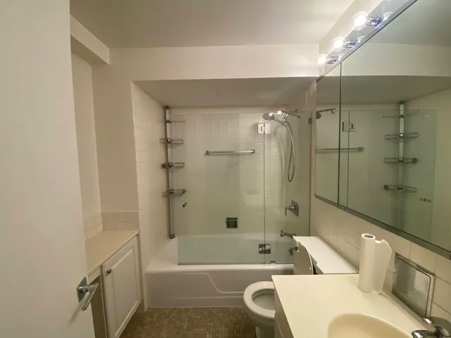 a bathroom with a bathtub a toilet and a shower