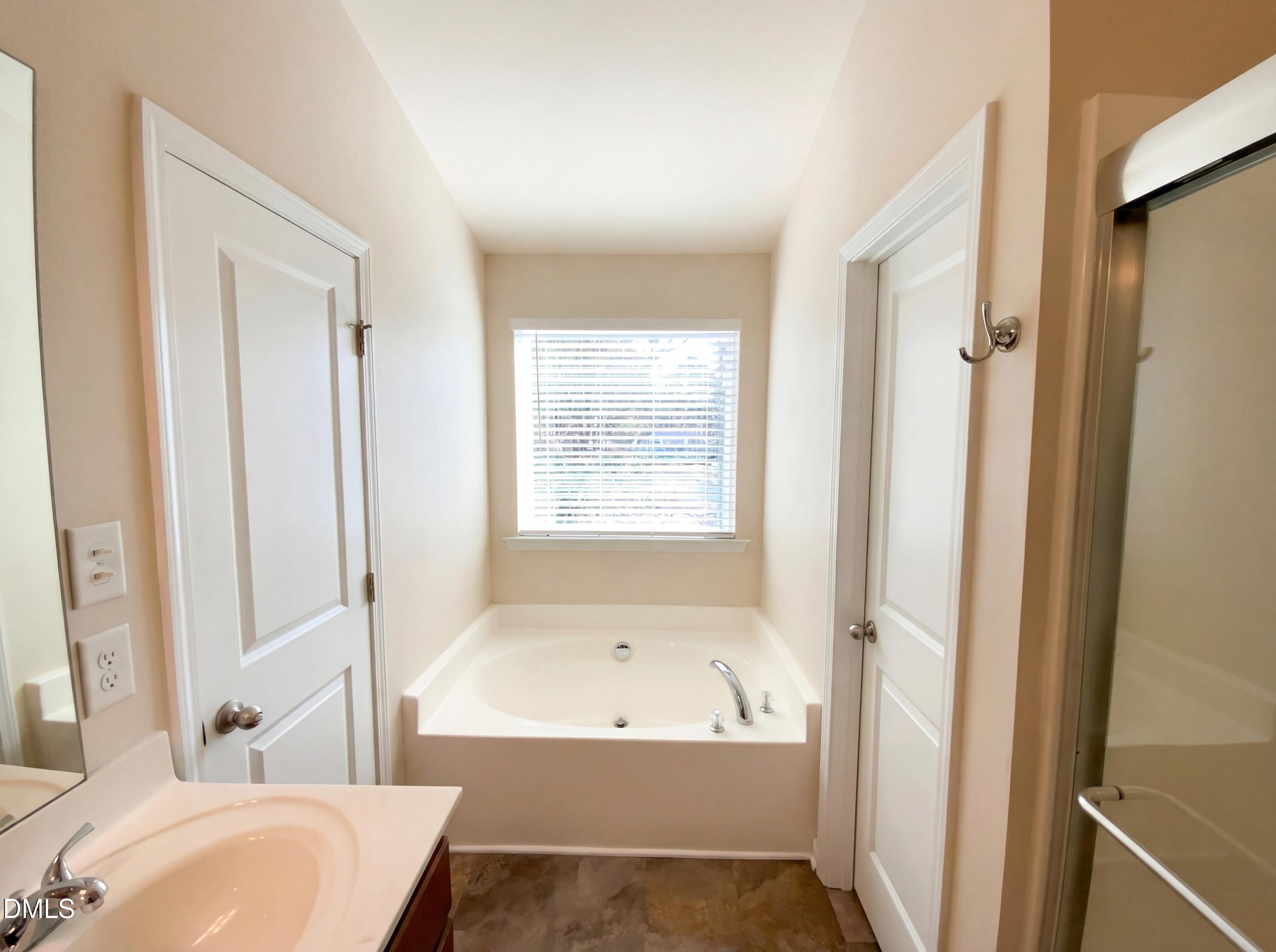 1661 Holly Grove Way Durham, NC 27713 - Photo 17 of 19 a bathroom with a bathtub and a shower