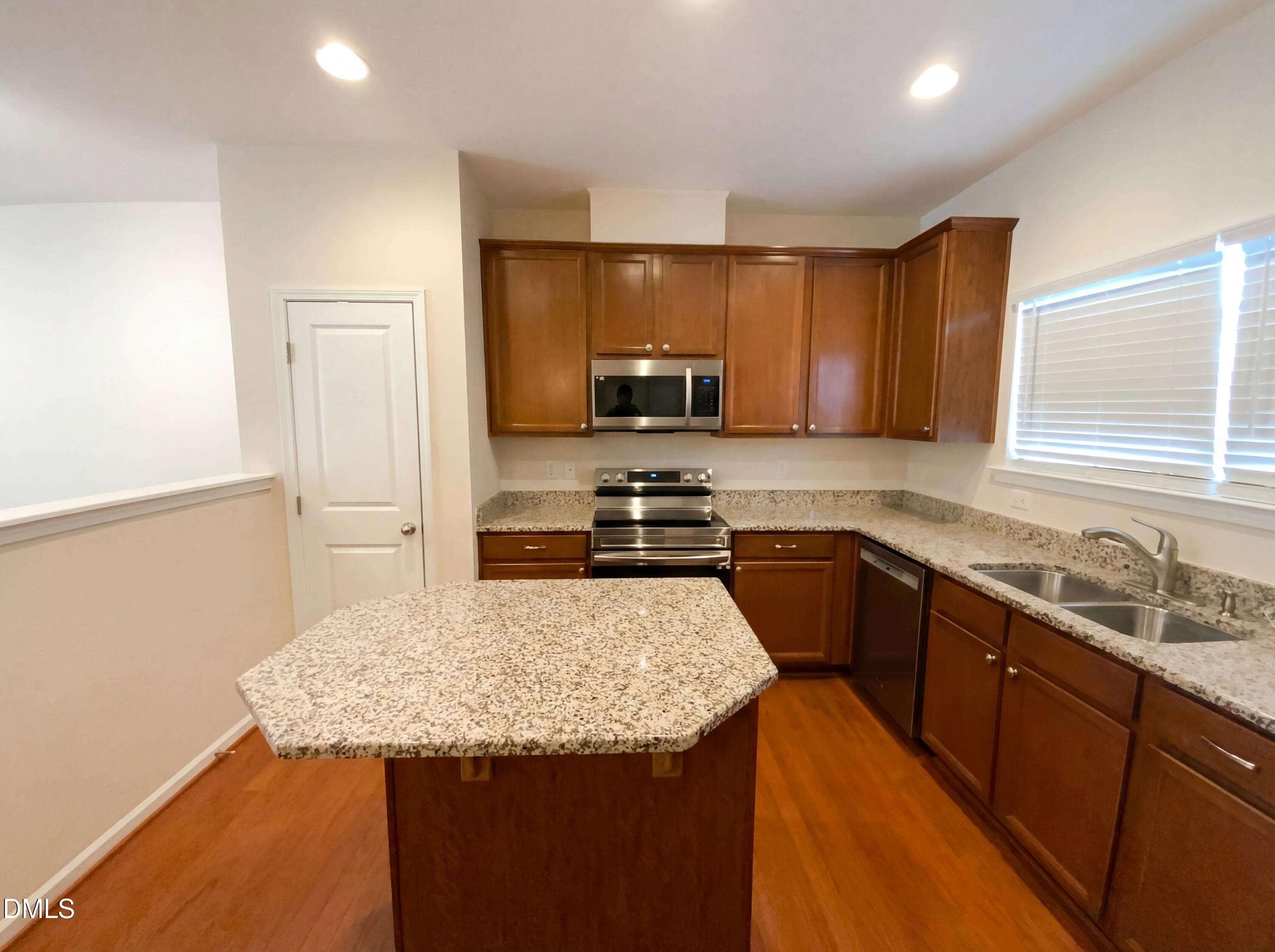 1661 Holly Grove Way Durham, NC 27713 - Photo 2 of 19 a kitchen with granite countertop a sink stove and refrigerator