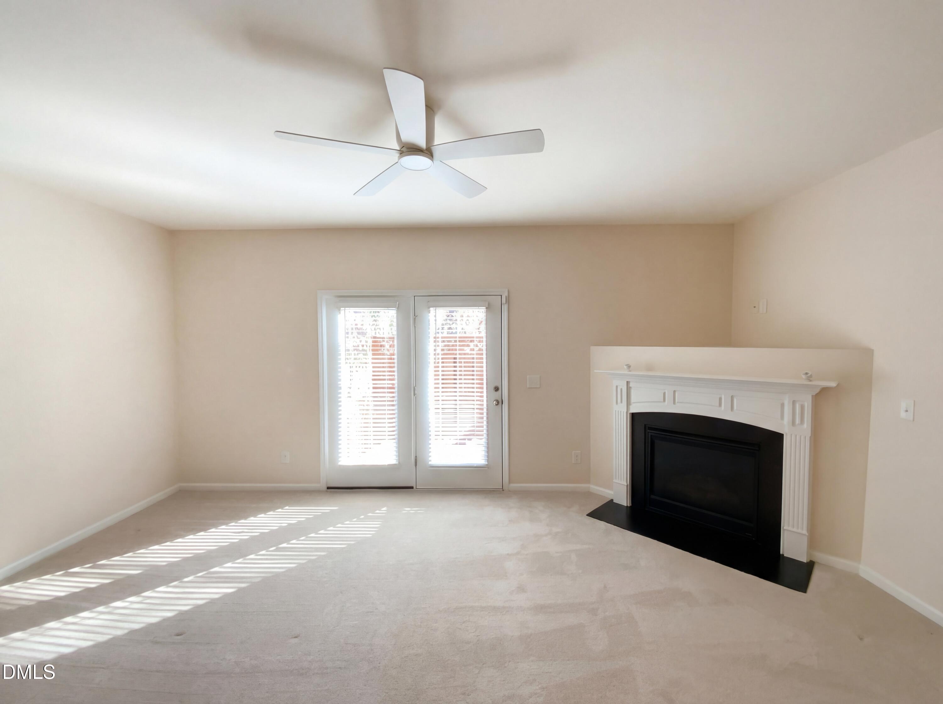 1661 Holly Grove Way Durham, NC 27713 - Photo 3 of 19 an empty room with windows and fireplace