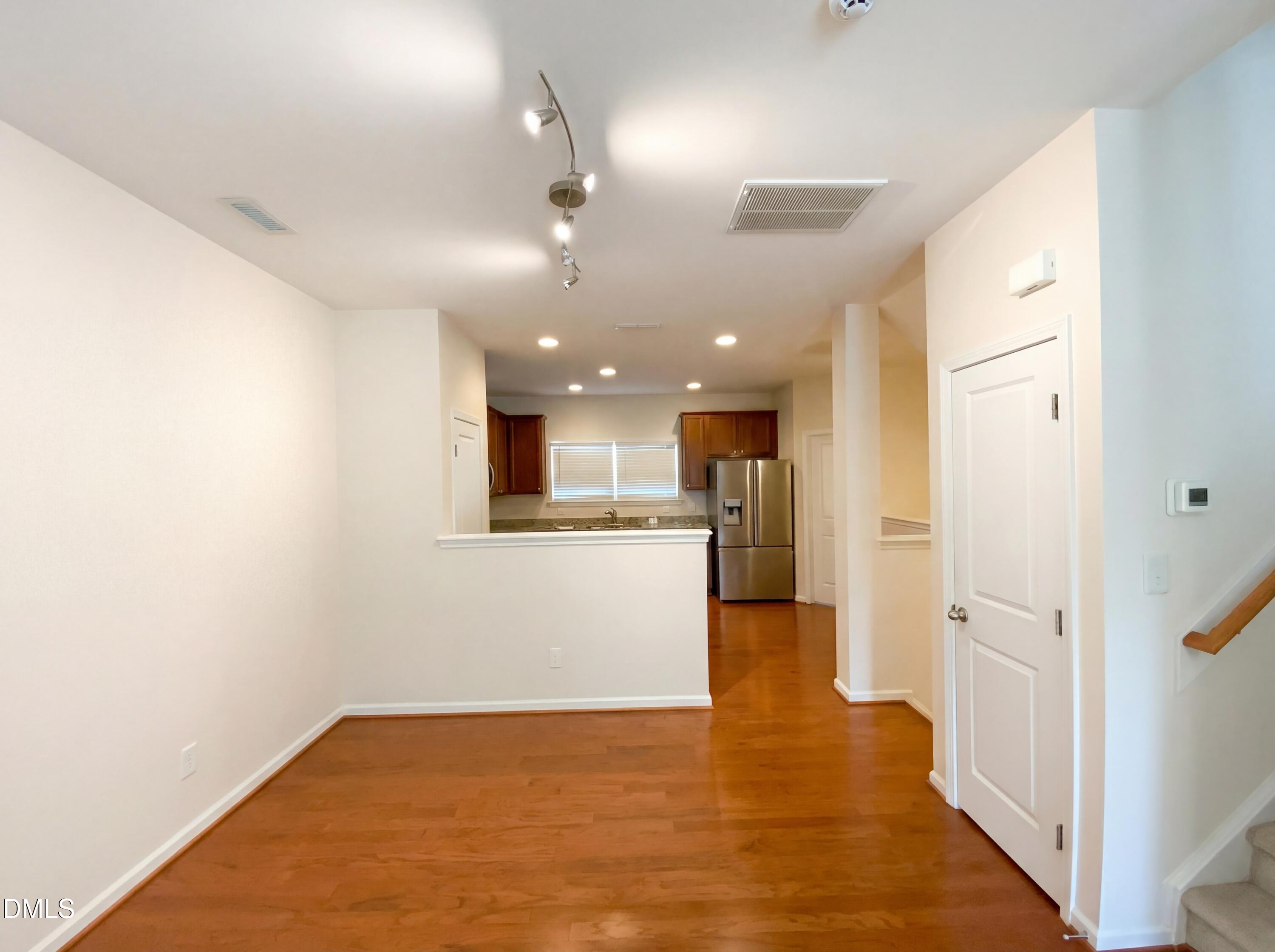 1661 Holly Grove Way Durham, NC 27713 - Photo 8 of 19 a view of a big room with wooden floor and a kitchen