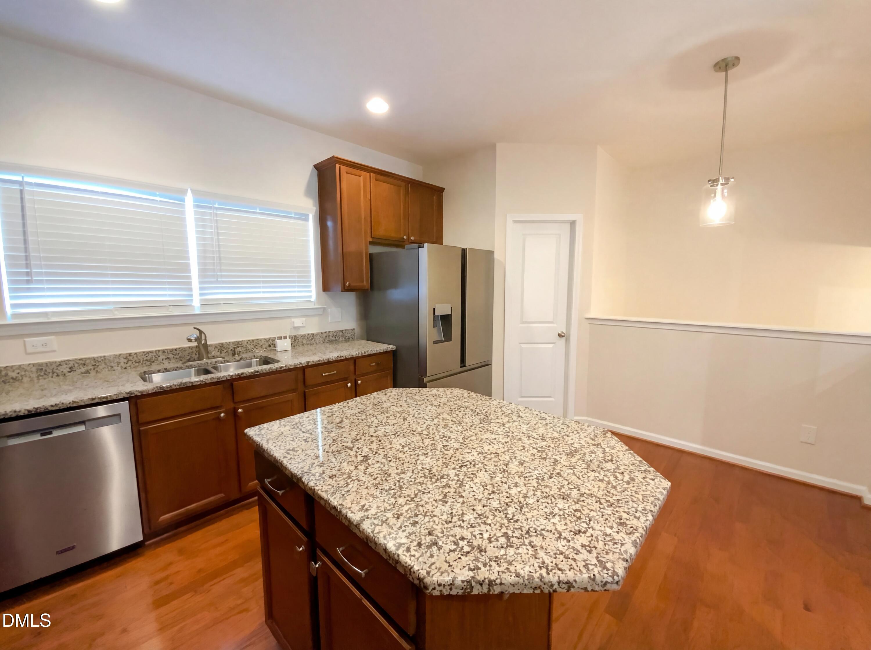 1661 Holly Grove Way Durham, NC 27713 - Photo 10 of 19 a kitchen with stainless steel appliances granite countertop wooden cabinets a sink and a stove
