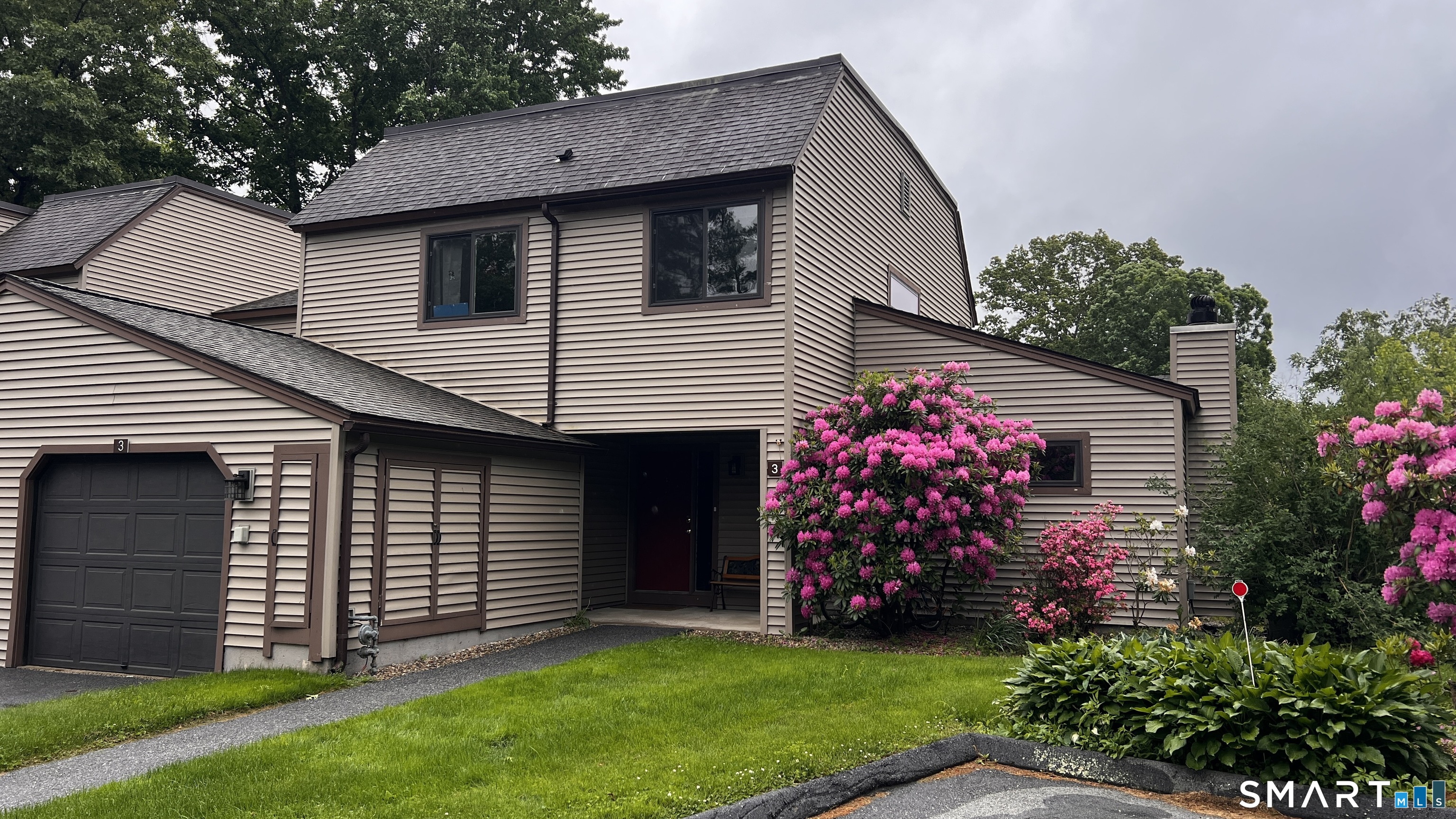 3 Walnut Lane, Unit 3 Avon, CT 06001 - Photo 2 of 22 a front view of a house with a garden