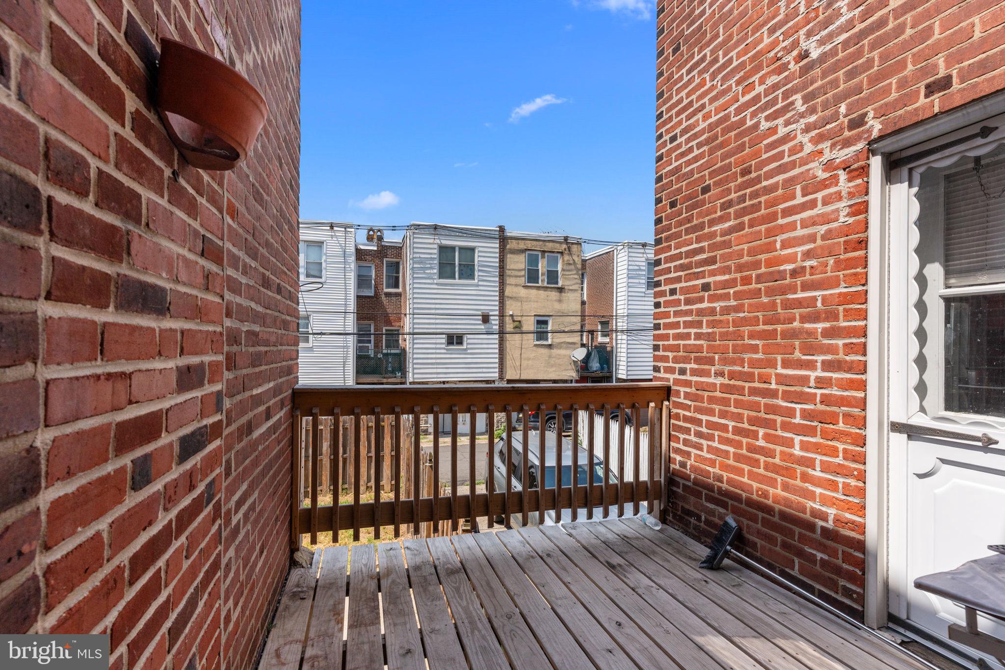 7122 Gillespie Street Philadelphia, PA 19135 - Photo 11 of 24 a view of a balcony with wooden floor and fence
