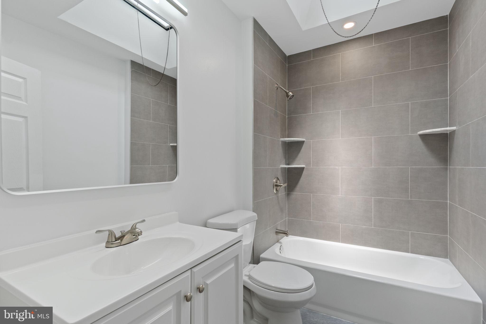 7122 Gillespie Street Philadelphia, PA 19135 - Photo 13 of 24 a bathroom with a sink toilet and shower