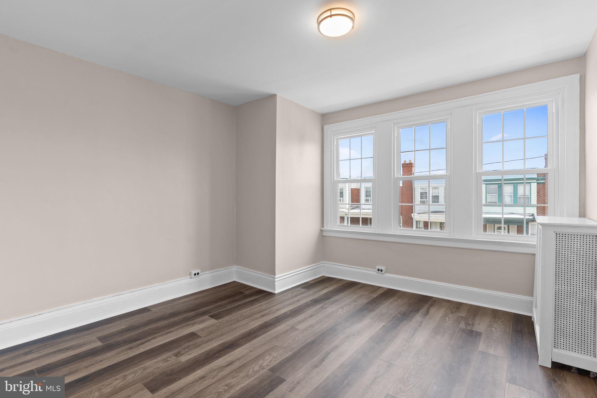 7122 Gillespie Street Philadelphia, PA 19135 - Photo 14 of 24 an empty room with wooden floor and windows