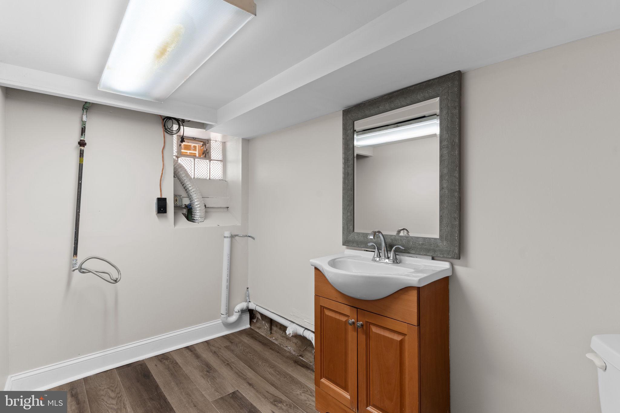 7122 Gillespie Street Philadelphia, PA 19135 - Photo 20 of 24 a bathroom with a sink a mirror and shower