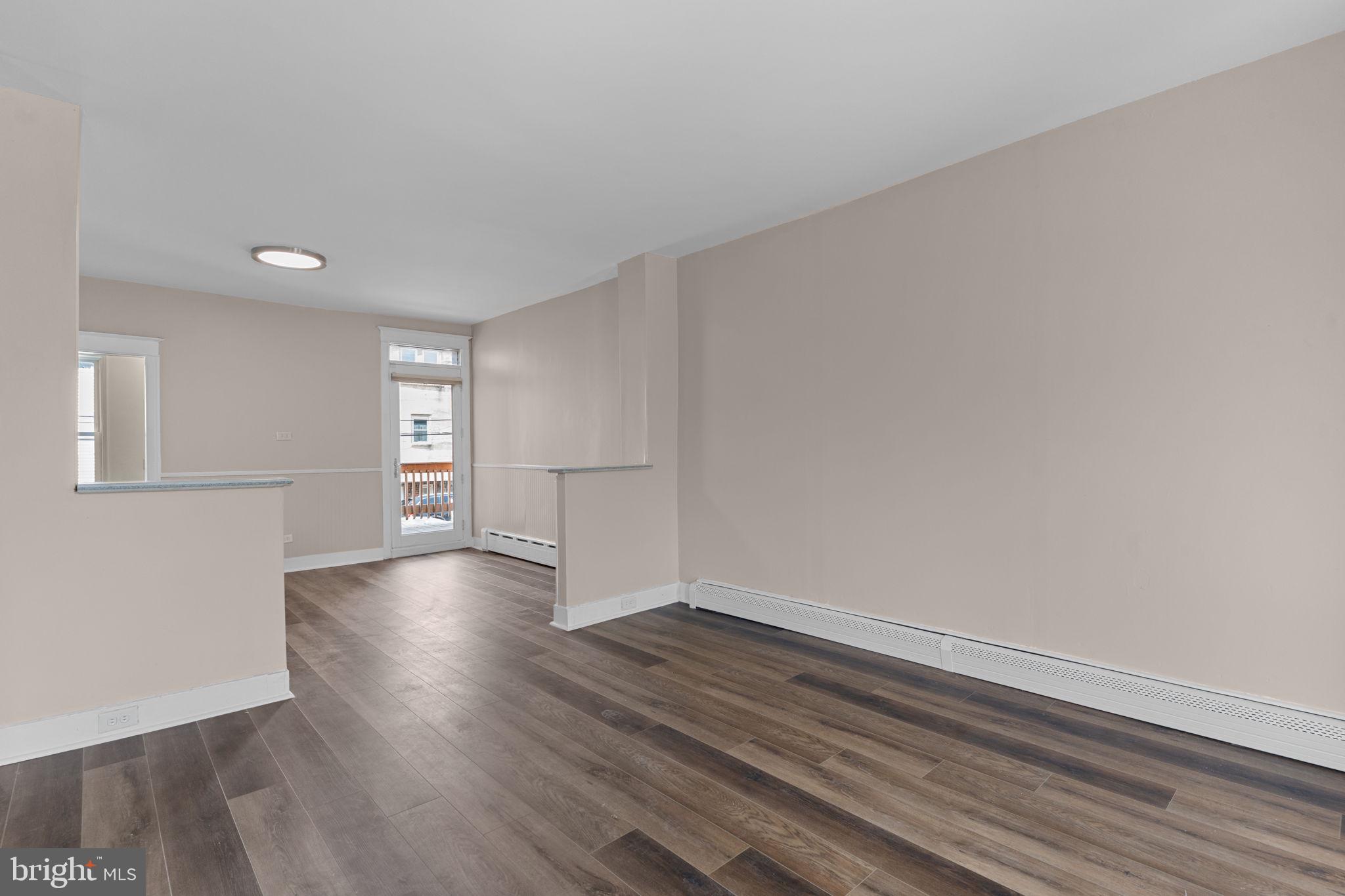 7122 Gillespie Street Philadelphia, PA 19135 - Photo 4 of 24 a view of empty room with wooden floor and fan