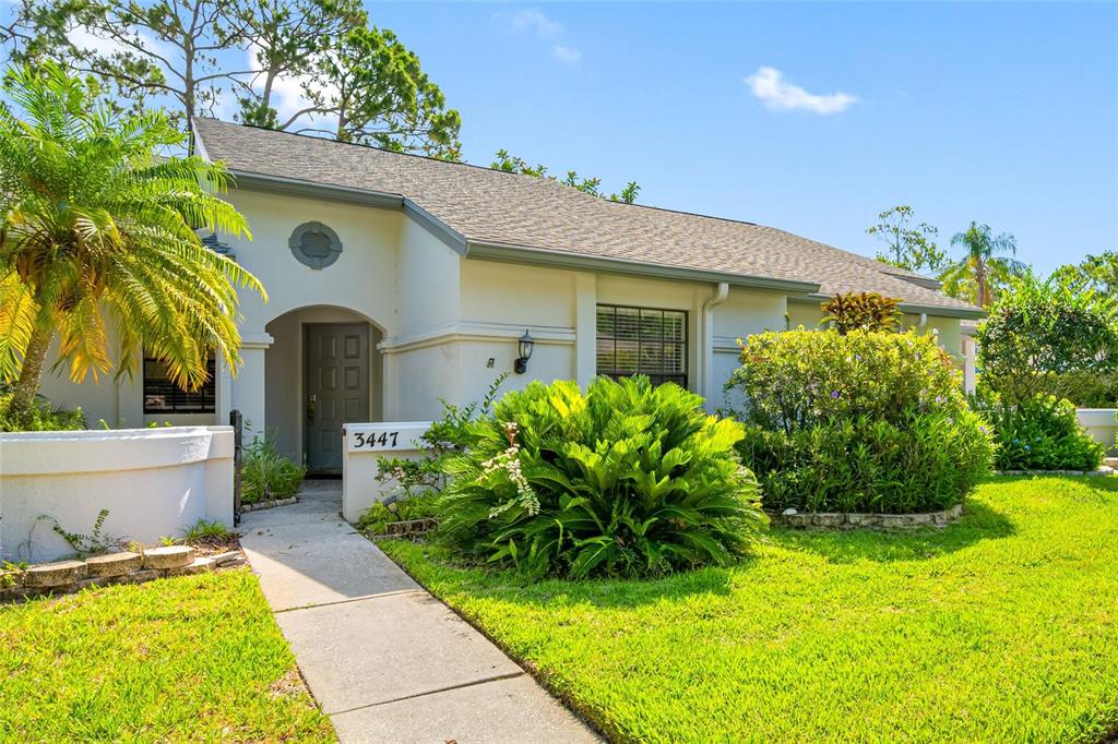 a front view of a house with garden