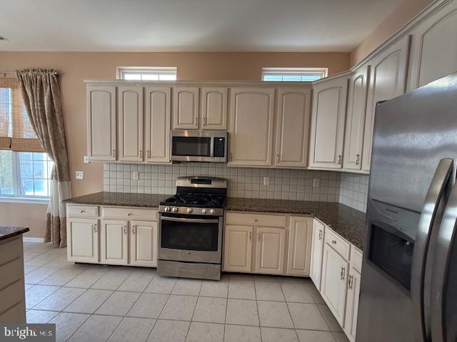 121 Einstein Way Cranbury, NJ 08512 - Photo 4 of 33 a kitchen with white cabinets sink and stainless steel appliances