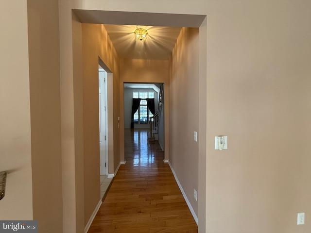 121 Einstein Way Cranbury, NJ 08512 - Photo 8 of 33 a view of a hallway with wooden floor and a bathroom
