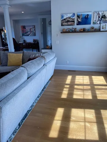 a living room with furniture and a floor to ceiling window