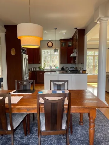 a kitchen with a table chairs sink and window