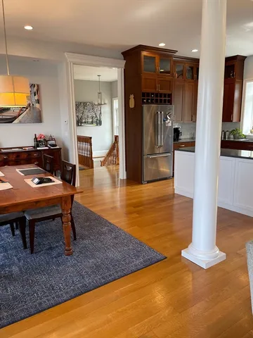 a dining room with table chairs and kitchen view