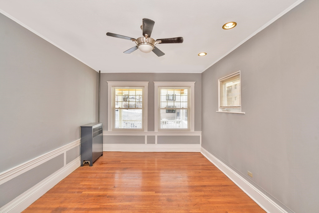 146 Homestead Street Boston, MA 02121 - Photo 1 of 40 a view of an empty room with a window and wooden floor